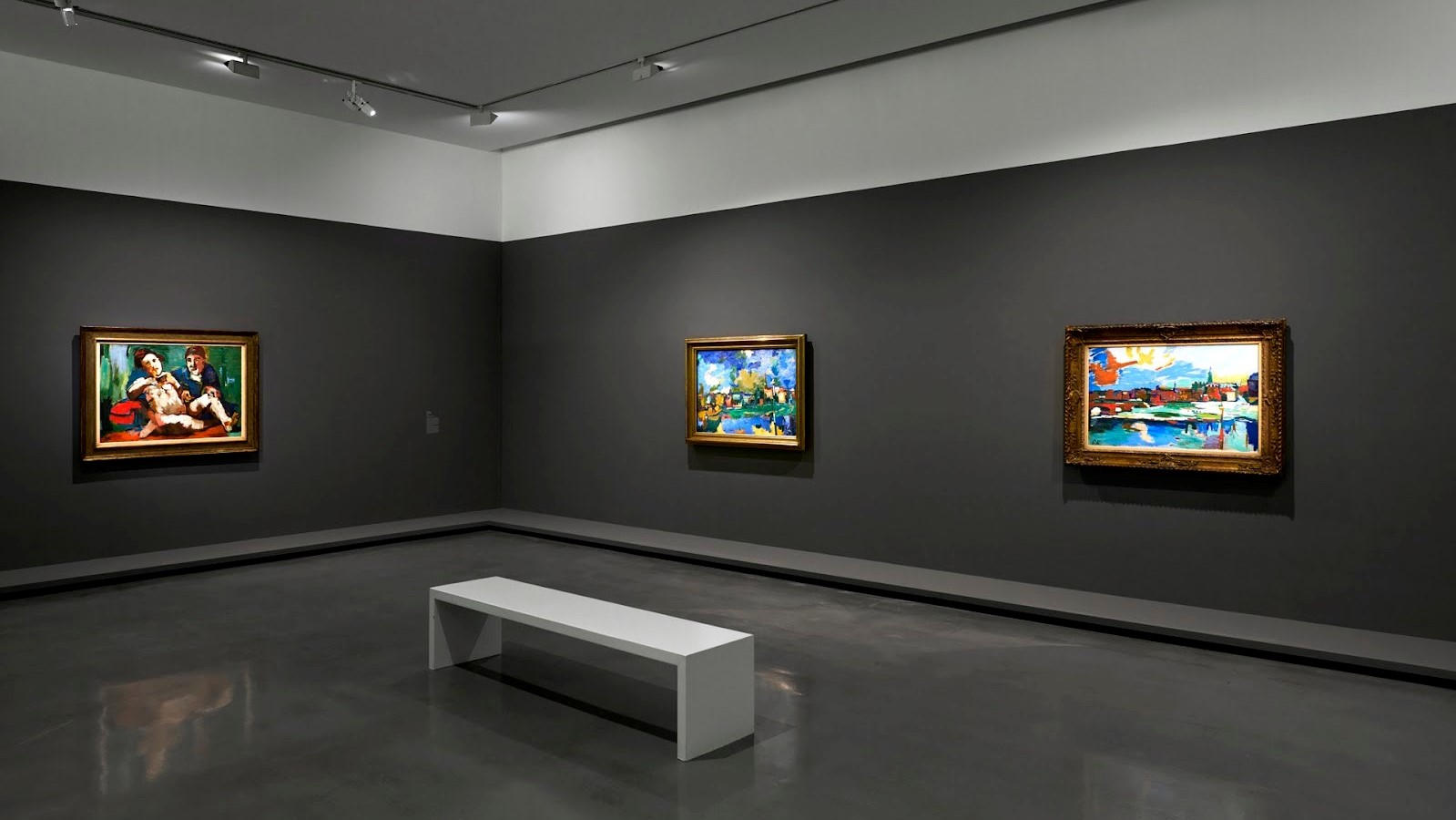 Three paintings on grey walls in Paris Museum of Modern Art.