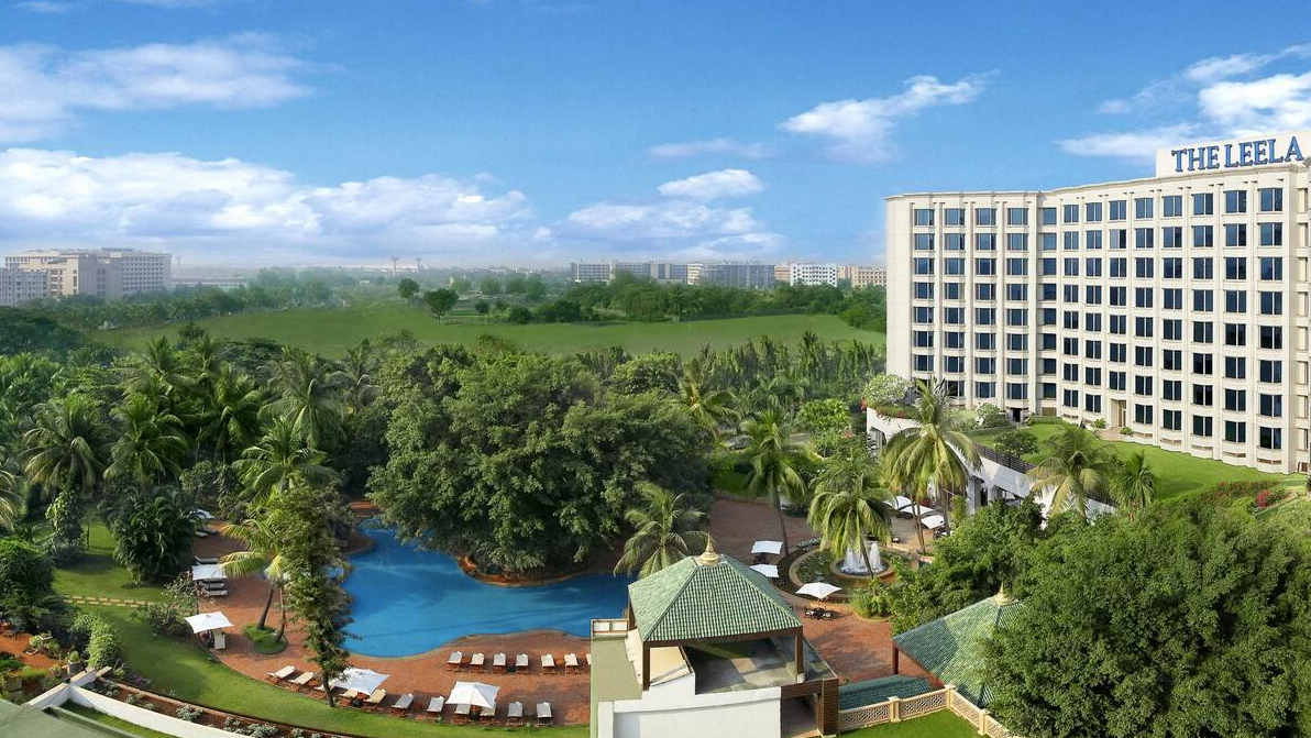 Bird perspective of The Leela, Mumbai at daytime with view of the hotel and pool area