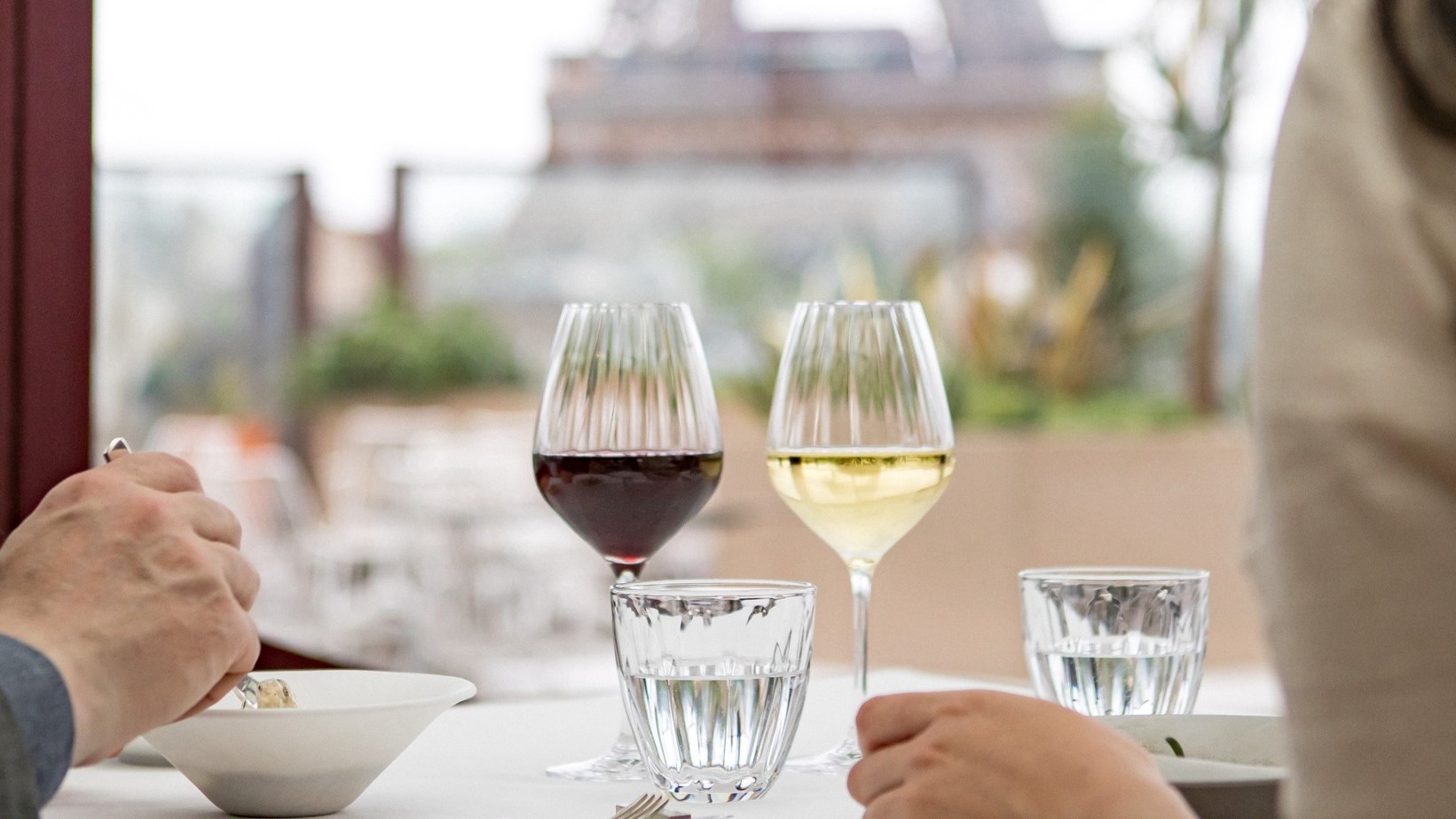A man and a woman drinking Red and white wine at Les Ombres - Musee du Quai Branly.