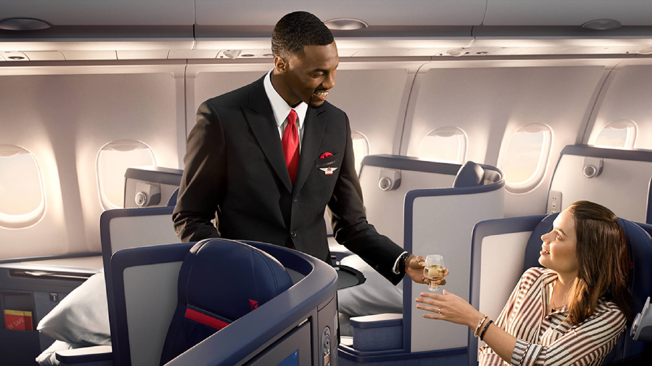 A woman receiving champagne at a businessclass trip