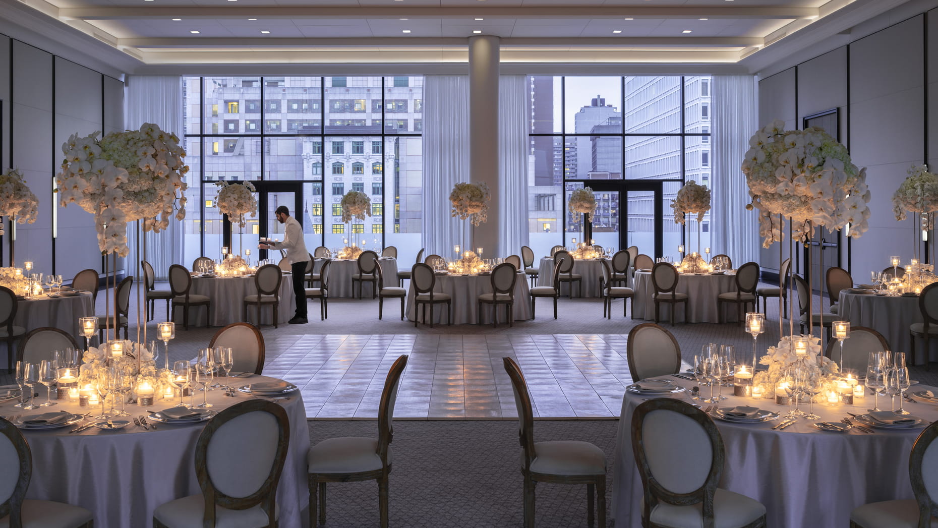 Dining area with white interior and white flowers at Four Seasons Hotel in Montreal