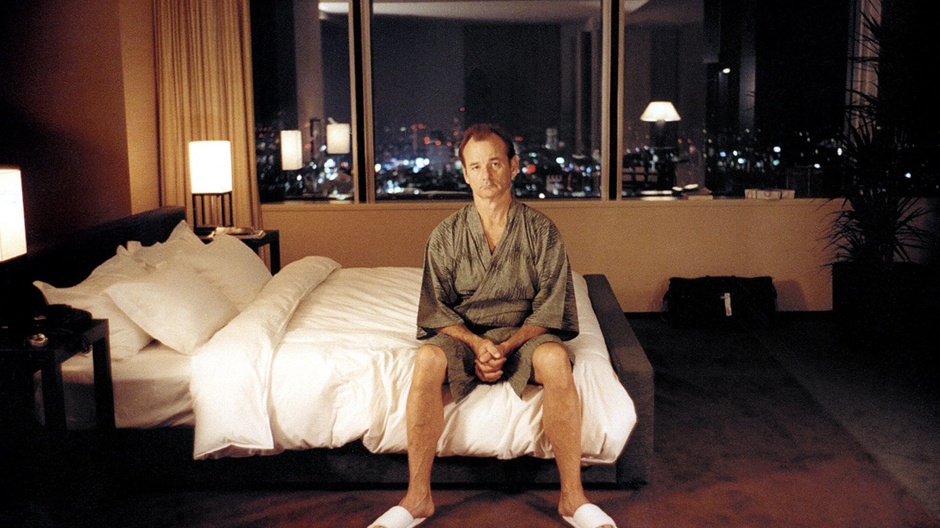 Bill Murray sitting on a bed in a hotel room at Park Hyatt in Tokyo