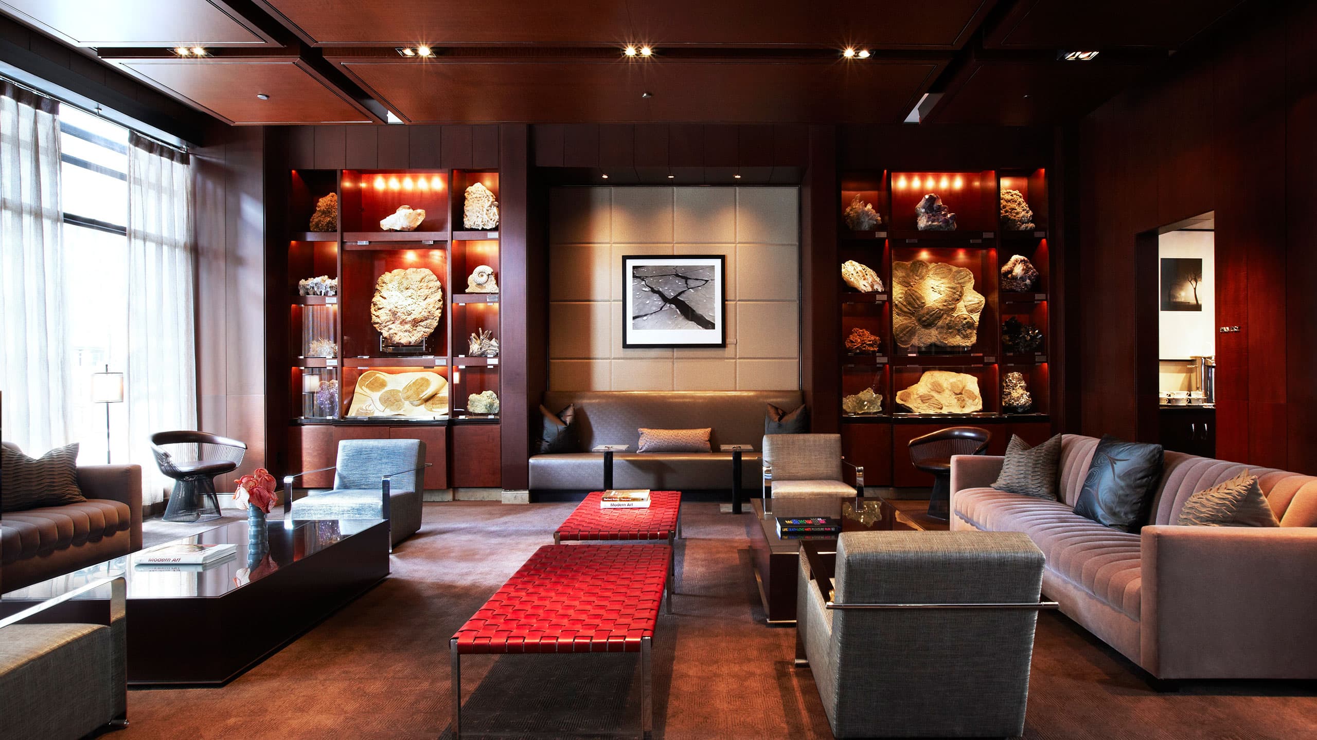 Suite at Park Hyatt in Chicago with red tables, large windows and couches