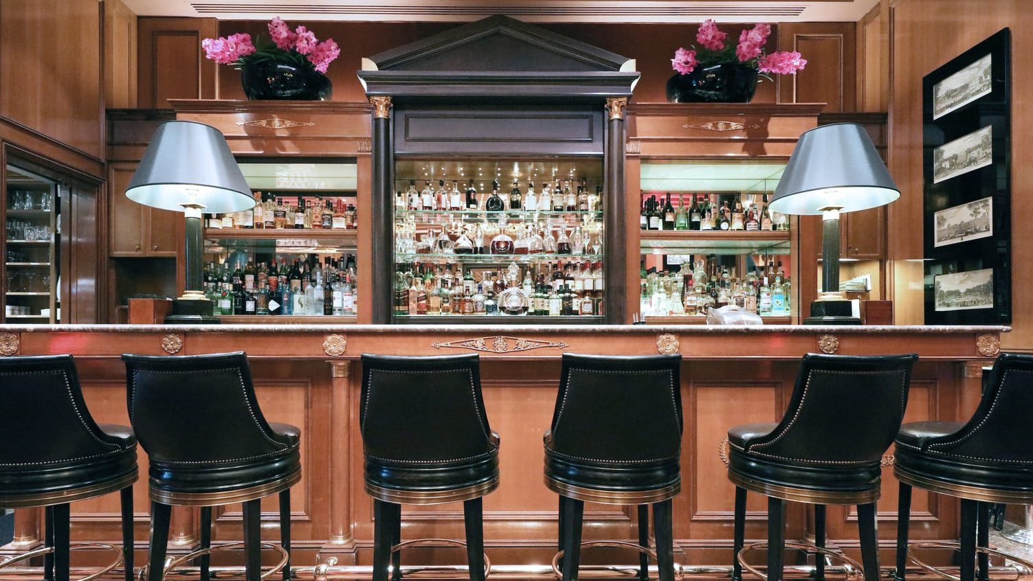 Le Bar inside Four Seasons Hotel George V with black chairs and cocktail closet.
