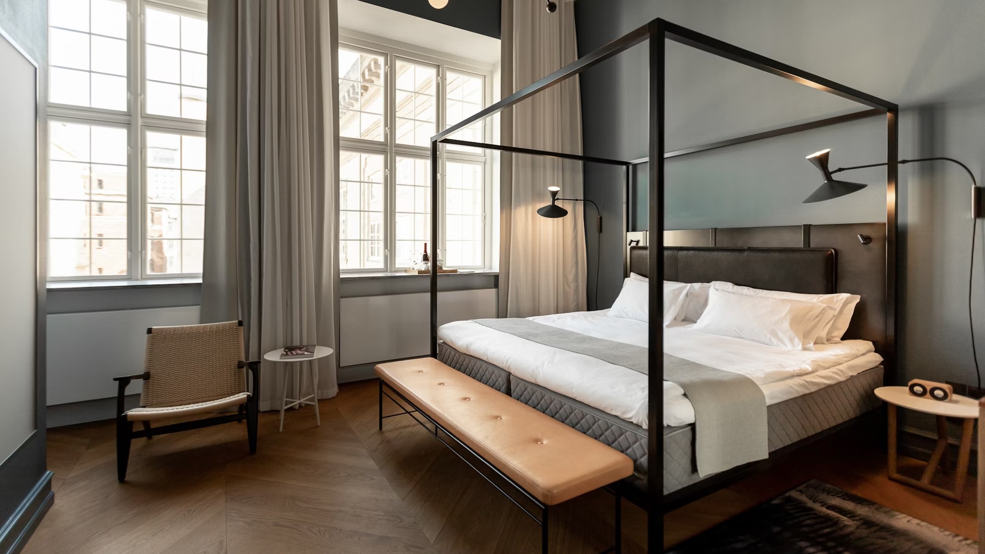 Suite with wooden floor and king size bed at Nobis hotel copenhagen
