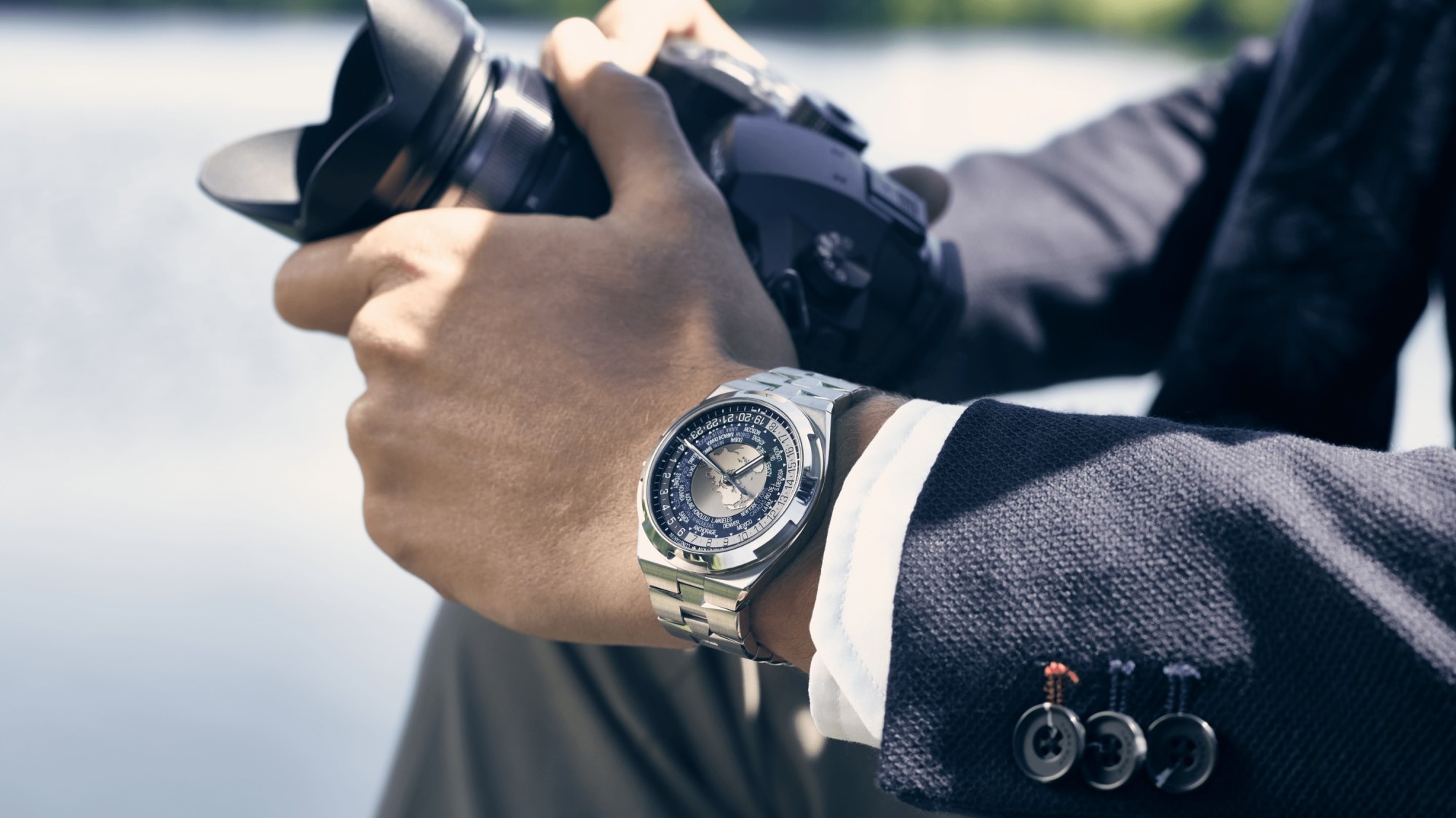 Man in a suit wearing Vacheron Constantin Overseas World Time.