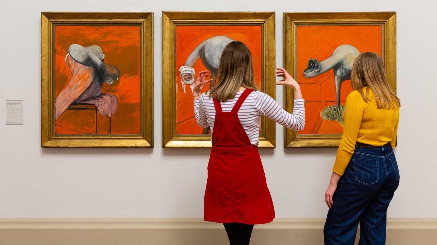 people looking at paintings at tate britain, one of the best art exhibitions in london