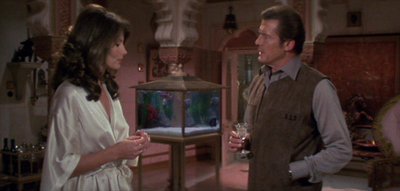 Roger Moore having a drink while talking to Maud Adams from the movie Octopussy 1983 in Taj Lake Place, Udaipur